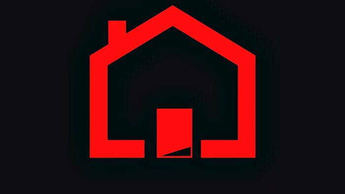Ilustracja przedstawia schematyczny obrazek domu z piecem. Czerwony dom na czarnym tle.