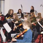 Młodzi ludzie grający na instrumentach.