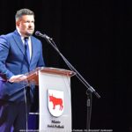 Mężczyzna przemawiający na scenie.