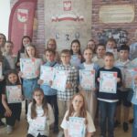 Uczniowie w towarzystwie opiekunów i gości prezentują dyplomy.