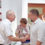 Urzędnicy w sali konferencyjnej urzędu podczas pożegnania dwojga emerytów.