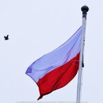 Biało-czerwona flaga na tle nieba.