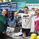 Wystawcy, młodzież i goście podczas prezentacji w liceum.