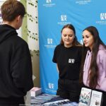 Wystawcy, młodzież i goście podczas prezentacji w liceum.