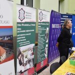 Wystawcy, młodzież i goście podczas prezentacji w liceum.