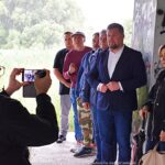 Grupa osób pod mostem.
