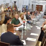 Spotkanie grupy osób dorosłych w sali konferencyjnej urzędu miasta.